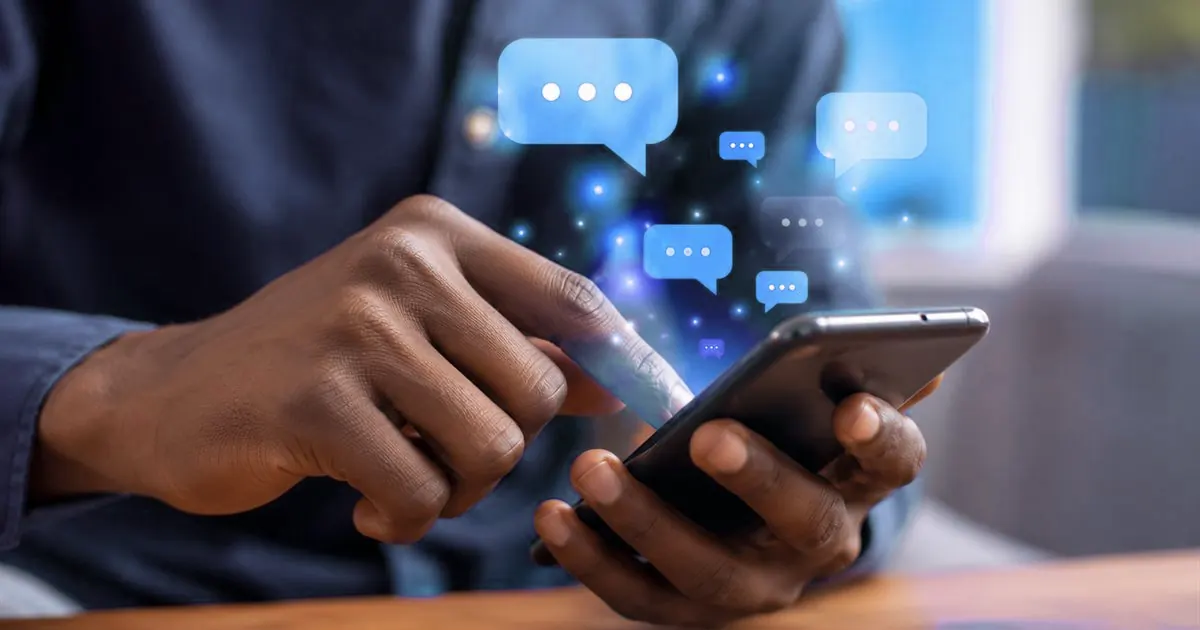 A hand tapping a phone with text message bubbles above it